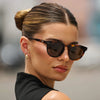 Woman wearing sunglasses with a blurred background