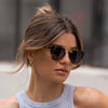 Woman wearing sunglasses with a blurred background
