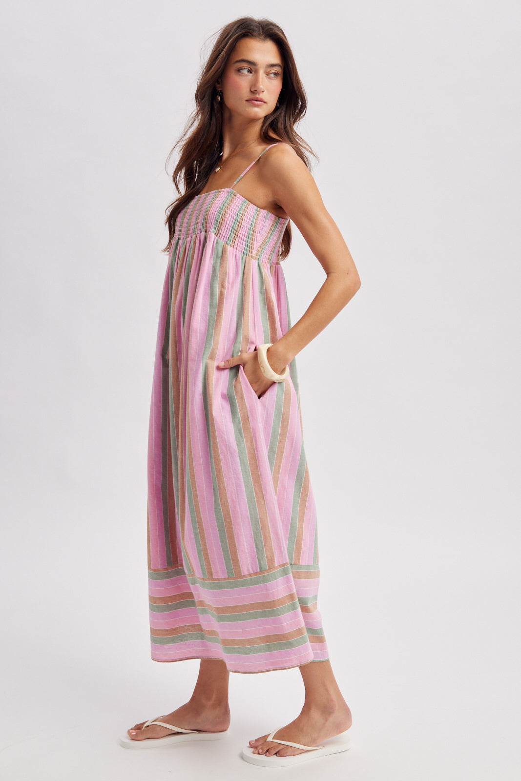Woman wearing a striped pink dress on a white background