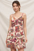 Woman wearing a floral dress against a plain background