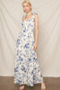 Woman wearing a floral dress against a plain background