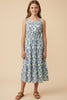 Young girl wearing a floral dress against a beige background