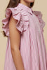 Pink and white striped dress with ruffled sleeves on a beige background