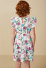 Woman wearing a floral dress with a beige background