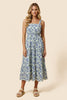 Woman wearing a blue floral dress on a beige background