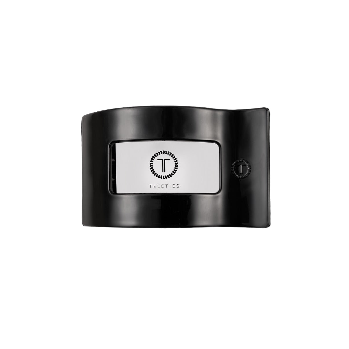 Black hair clip with a white label featuring a logo and text on a white background