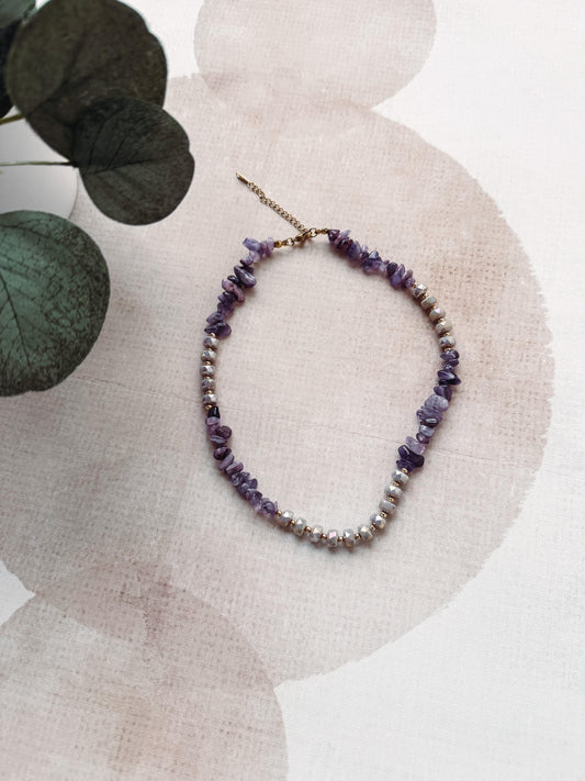 Necklace with purple beads on a neutral background