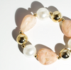 Bracelet with pearls and gold beads on a white background