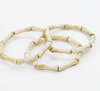 Set of three bone-like bracelets on a white background