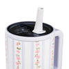 White mug with floral pattern, black lid, and white straw on a white background