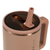 Rose gold mug with straw lid on a white background