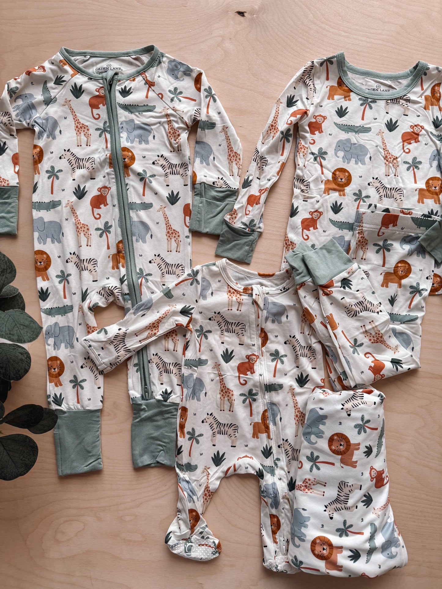 Set of children's pajamas with animal pattern on a wooden surface