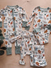 Set of children's pajamas with animal pattern on a wooden surface