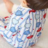 Baby wearing a onesie with heart-shaped text and stripes