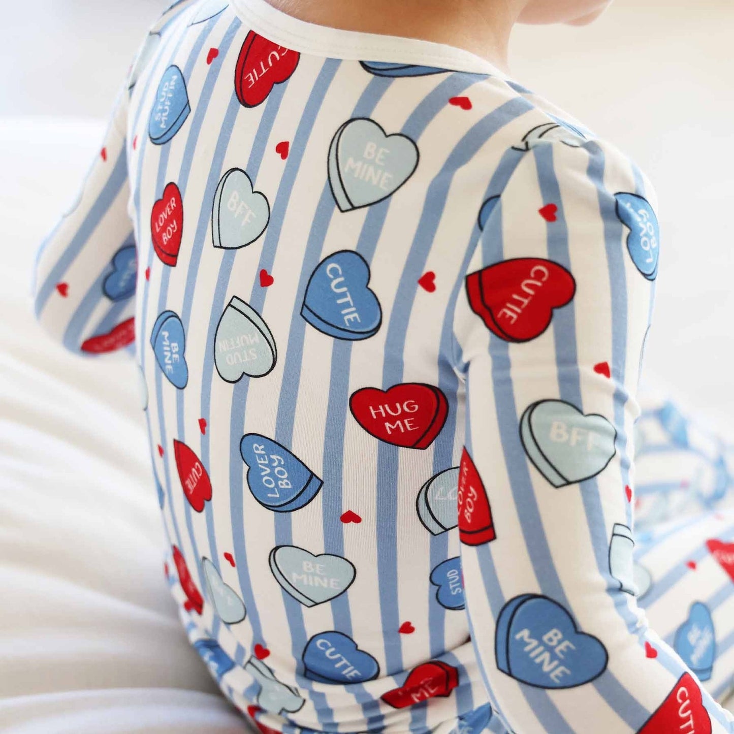 Children's shirt with heart patterns and text on a white background