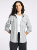 Person wearing a gray flannel shirt over a white t-shirt on a white background