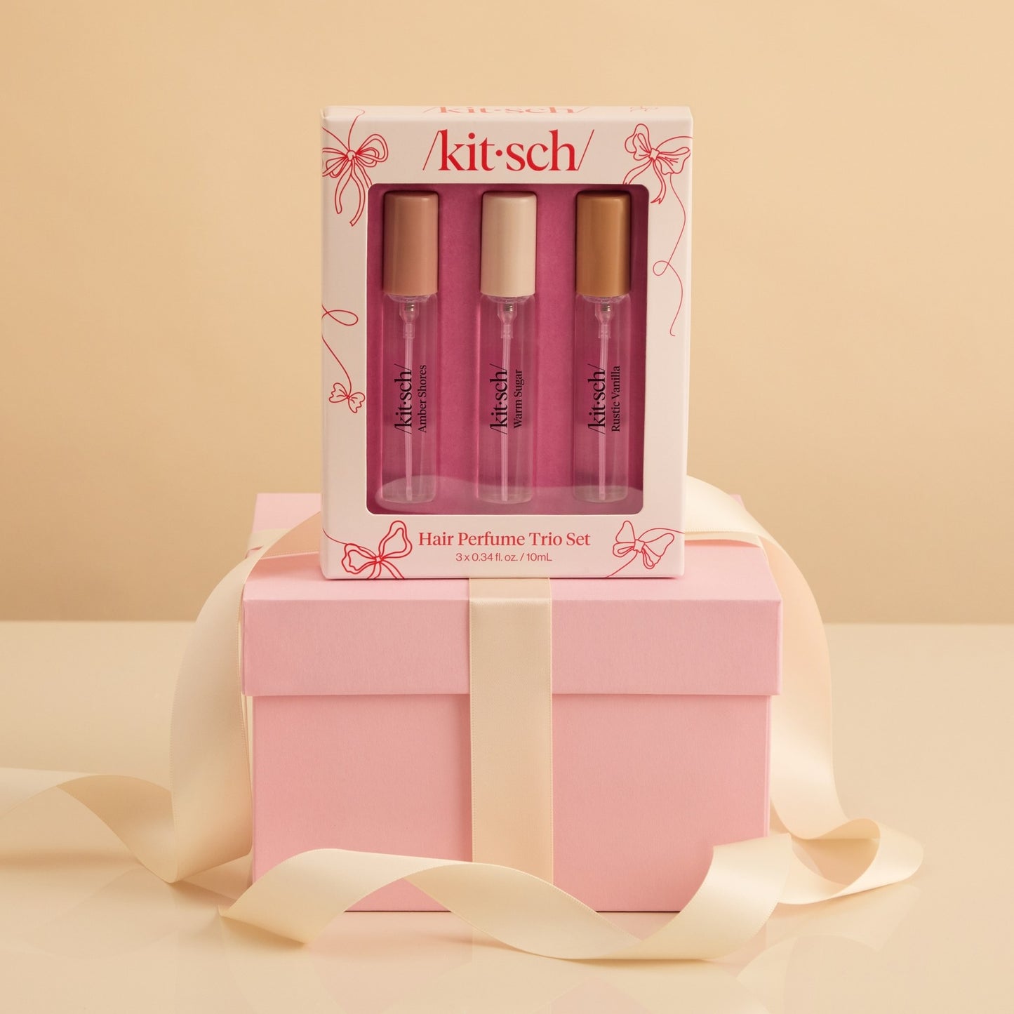 Kit-sch hair perfume trio set with pink packaging on a beige background