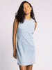 Woman wearing a light blue sleeveless dress against a plain background