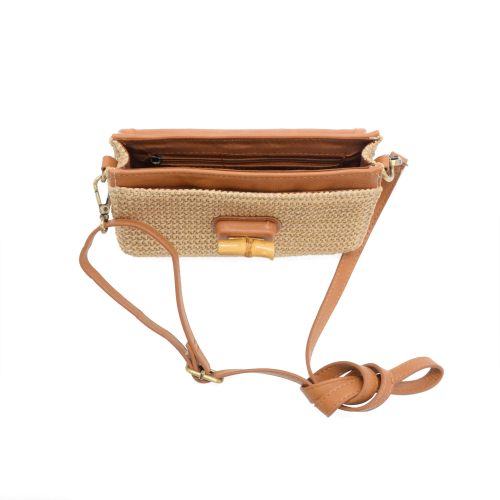 Brown woven handbag with leather strap on a white background