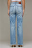 Rear view of a person wearing light-wash blue denim jeans with a straight-leg or wide-leg fit, frayed hems, and back patch pockets, paired with a white cropped top and heels against a plain beige studio background.