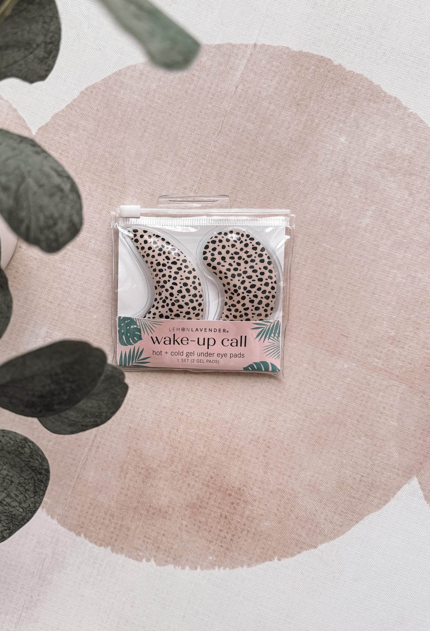 Pack of eye pads with leopard print design on a pink floral background