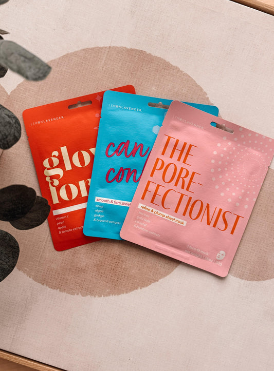 Three skincare mask packets labeled 'glofox', 'cancon', and 'The Porefectionist' on a textured surface.