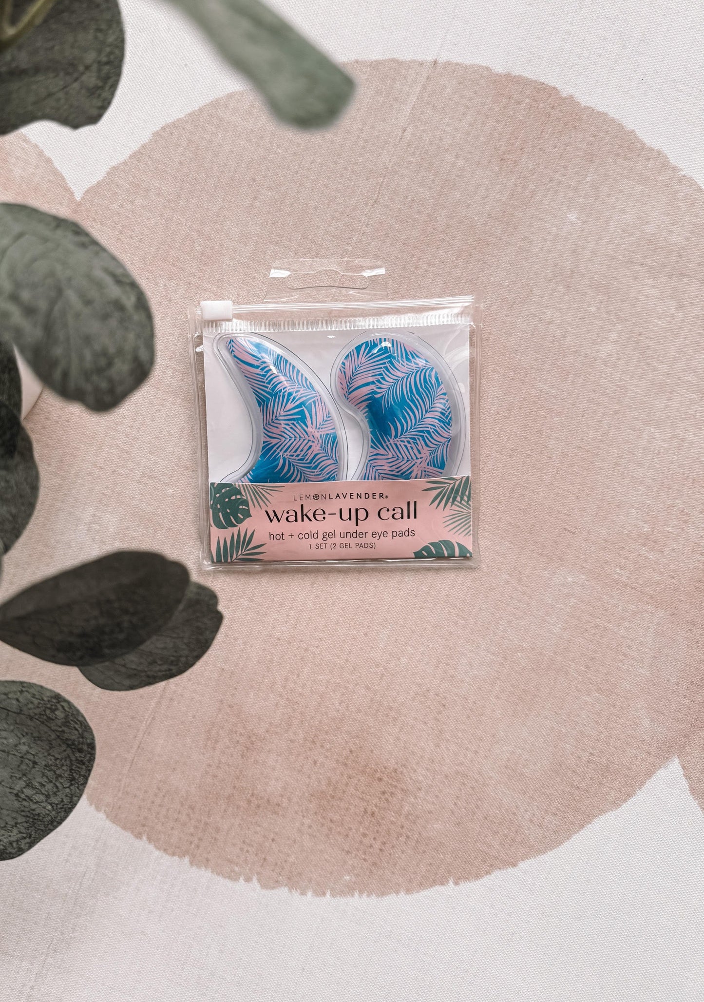 Pack of eye patches with tropical design on a pink fabric background