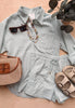 Light blue striped shirt and shorts set with accessories on a wooden surface