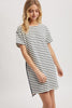 Woman wearing a black and white striped dress on a white background