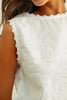 Close-up of a white lace top worn by a person