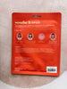 Red facial mask packaging with text and images on a textured beige background