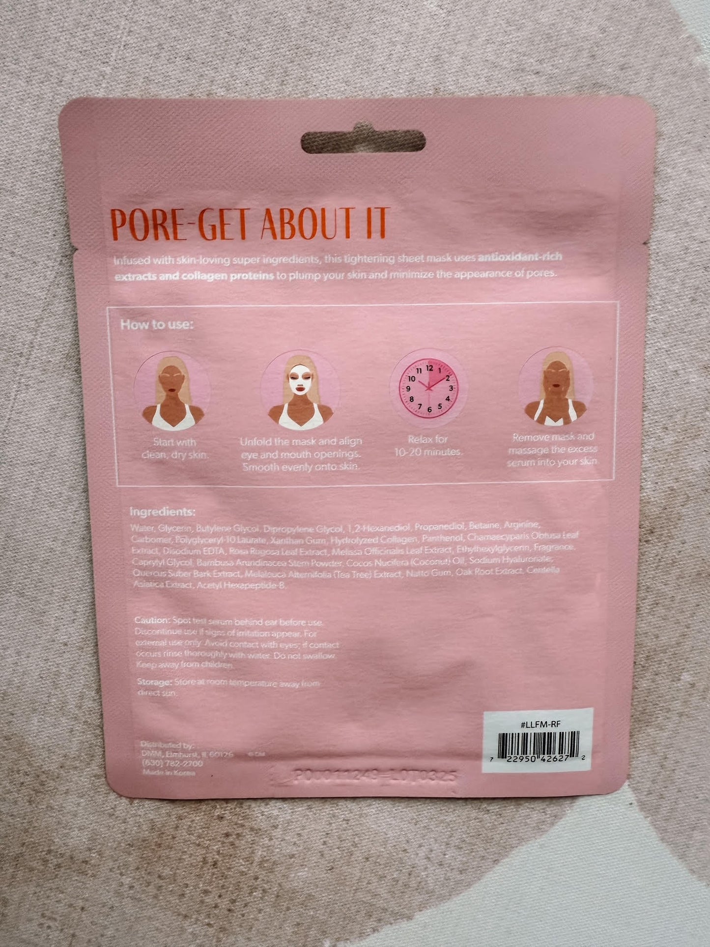 Pink packaging with text and icons on a textured surface