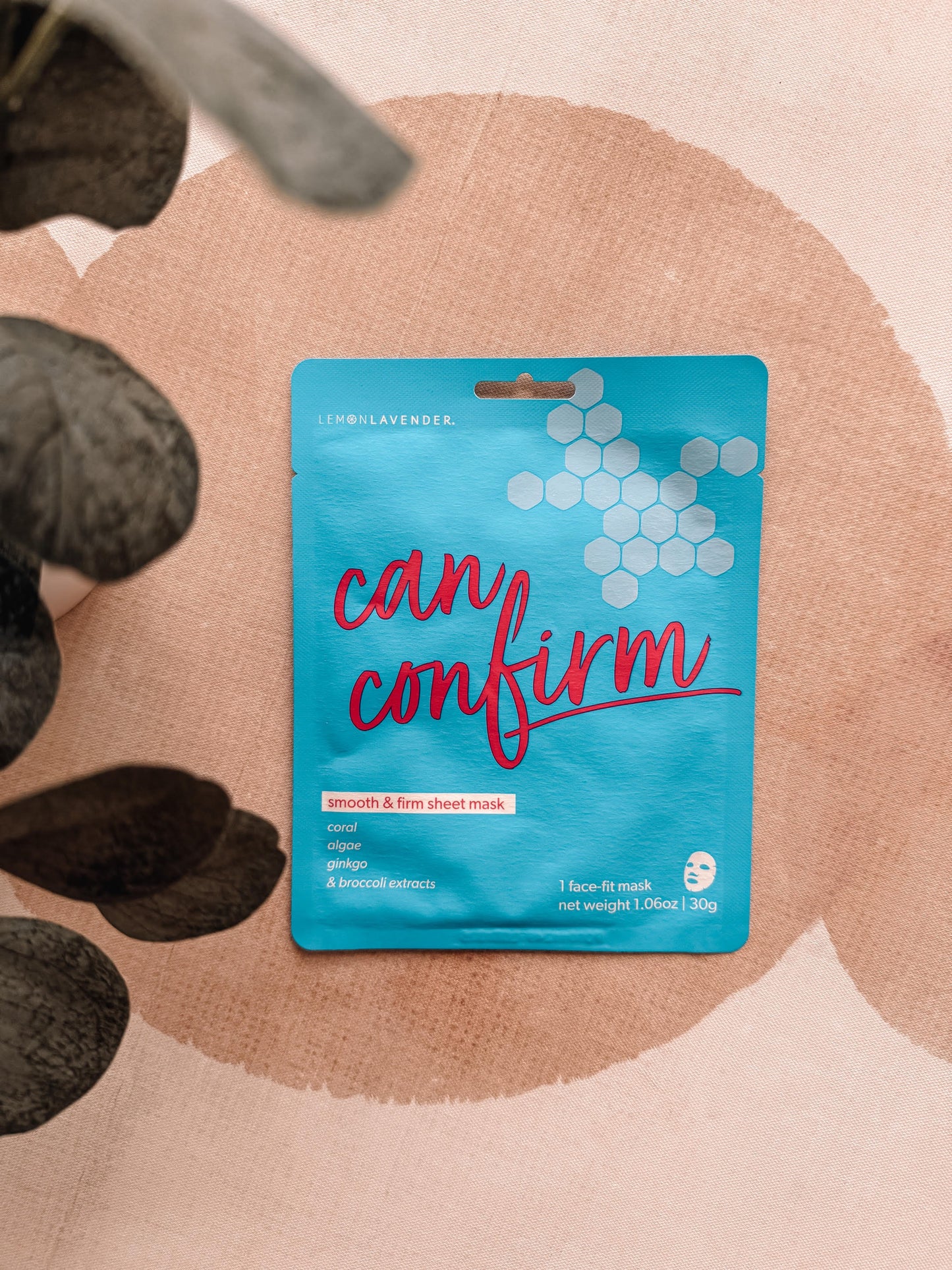 Sheet mask packaging with 'can confirm' text on a pink background
