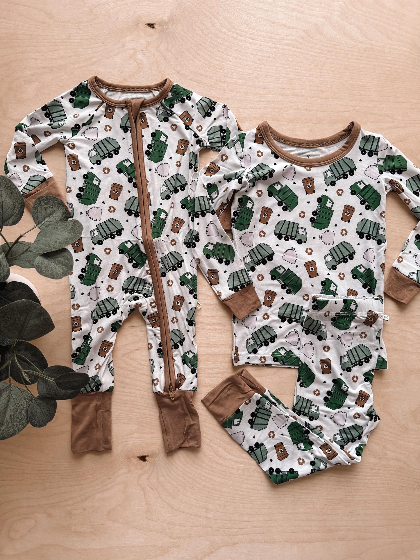 Children's onesie and shirt with truck pattern on a wooden surface