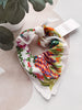 Colorful floral-patterned scrunchie on a light background