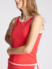 Woman wearing a red tank top with white trim on a light gray background