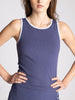 Woman wearing a blue tank top against a light gray background